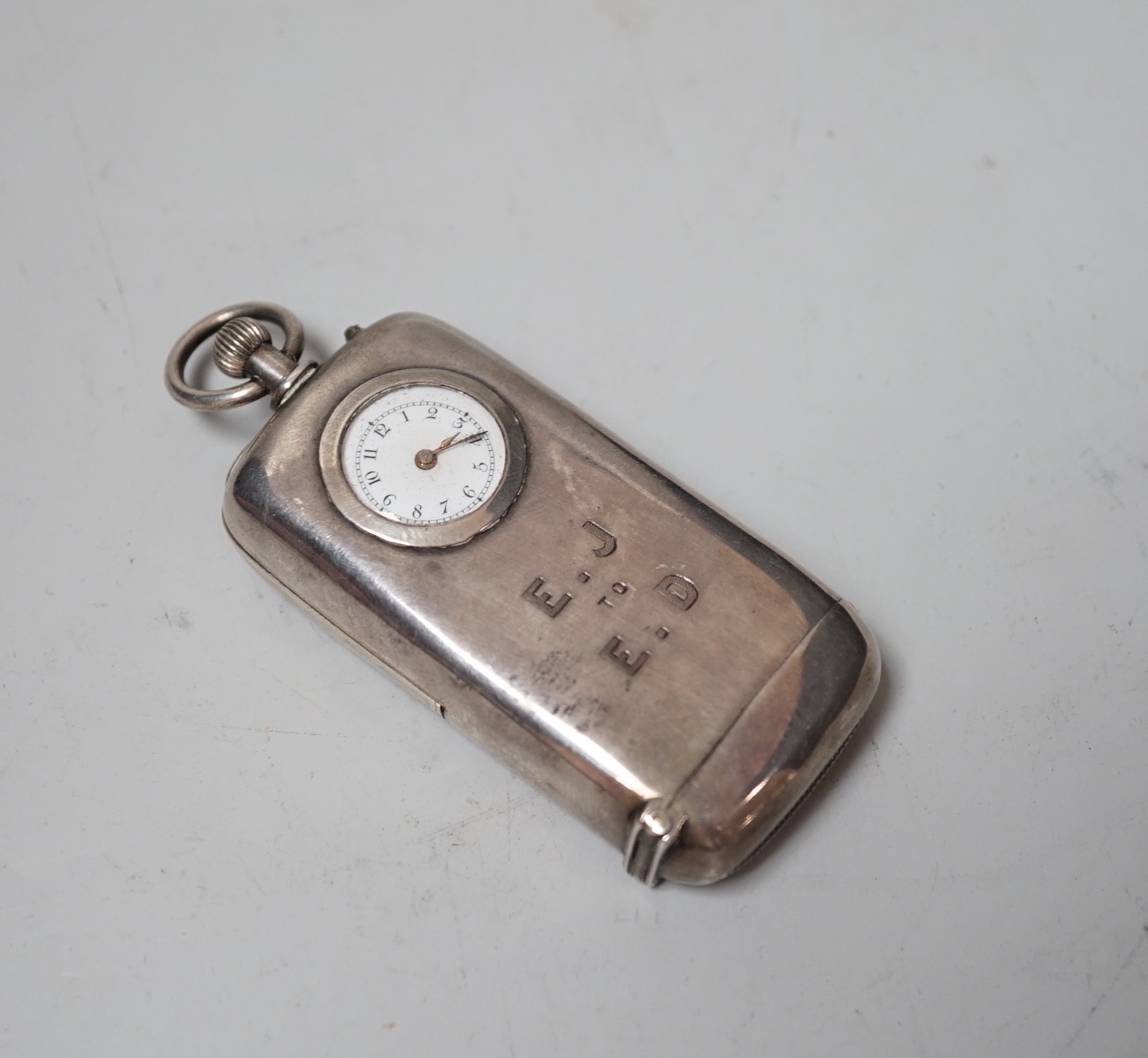 A late Victorian silver combination vesta and sovereign case with inset timepiece, William Neale & Son, Chester, 1887, 75mm.